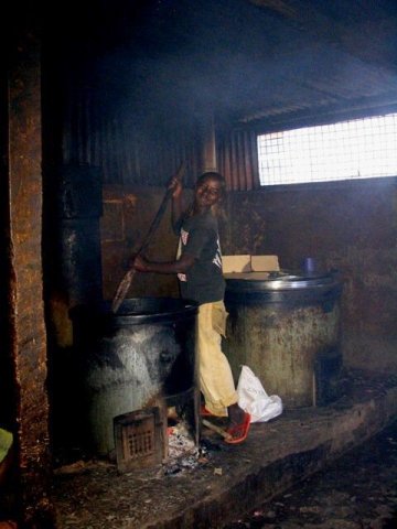 Školská kuchyňa...Simon pomáha pri príprave čaju s mliekom, alebo ugali, Nairobi, február 2011